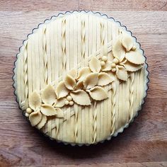 an uncooked pie sitting on top of a wooden table