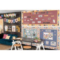 a living room filled with furniture next to a chalkboard wall covered in stickers