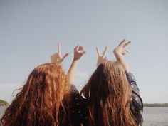 two girls with their hands in the air