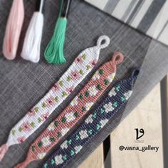 three different colored crocheted items sitting on top of a table