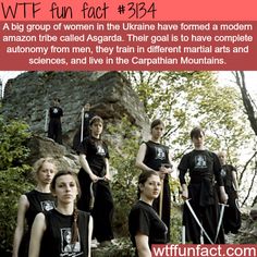 a group of young people standing next to each other in front of a rock formation