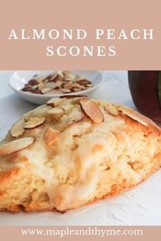 almond peach scones on a white plate with a bowl of fruit in the background