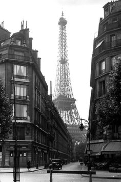 the eiffel tower towering over the city of paris in black and white photo