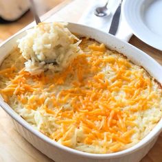 a casserole dish with mashed potatoes and cheese