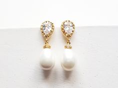 Pearl teardrop bridal Earrings in gold, silver and rose gold. A gorgeous cream shell pearl tear drop on a gold cubic zircon tear drop earring post. A extremely elegant designs. Very versatile, perfect for a bride or even as a gift for bridesmaid or mother of bride. Details: Material: 16k gold, rhodium or rose gold plated brass, cubic zircon Length: approx 1.5 inches Earrings ONLY, Matching necklace available at extra cost - https://www.etsy.com/listing/246313605 This item is in-stock and ready t Elegant Gold Pear-shaped Bridal Earrings, Gold Pear-shaped Cubic Zirconia Bridal Earrings, Gold Teardrop Earrings With Pearl Drop For Anniversary, Gold Teardrop Cubic Zirconia Earrings, Pear-shaped Pearl Charm Wedding Earrings, Pear Shaped Teardrop Earrings With Pearl Drop For Wedding, Gold Pear-shaped Pearl Drop Earrings, Gold Pear-shaped Bridal Earrings With Pearl Charm, Pear-shaped Gold Pearl Earrings