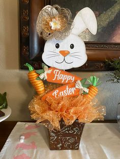 an easter bunny decoration with carrots in a basket