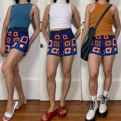 three young women standing next to each other in front of a door wearing short shorts