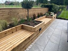 a wooden bench sitting next to a garden