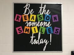 a black and white sign that says be the reason someone smiles today with colorful blocks on it