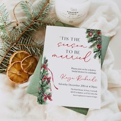 this is an image of a christmas card and candle on a blanket with pine branches