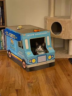 a cat is sitting in a toy truck on the floor