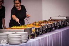 two women preparing food at a buffet table