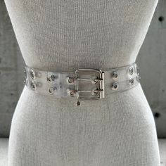 Y2K transparent double grommet belt, two row eyelet belt, hollow gothic style, grunge punk fashion, pop culture, maximalist chic aesthetic Step into the rebellious allure of Y2K fashion with this Transparent Double Grommet Belt - a nod to the iconic era of pop culture and grunge punk fashion. The edgy design features two rows of meticulously crafted eyelets, creating a strikingly hollow gothic style that merges seamlessly with contemporary maximalist chic aesthetics. Crafted with precision, the transparent material adds a futuristic touch, allowing your outfit to peek through the double grommet details. This belt is a sartorial statement, effortlessly capturing the essence of Y2K rebellion and bold self-expression. The grunge punk vibes are amplified by the industrial-inspired grommets, ex Grunge Punk Fashion, Grunge Culture, Y2k Transparent, Double Grommet Belt, Punk Mode, Eyelet Belt, Oversized Band Tee, Grommet Belt, Edgy Design