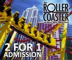 the roller coaster is in front of tall buildings