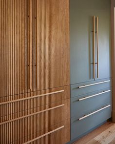 an empty room with wooden walls and drawers