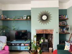 a living room filled with furniture and a fire place in front of a flat screen tv