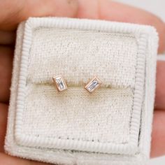 Tiny simple rectangle stud earrings with sparkly bezel set baguette lab-grown diamonds. They measure 4.8mm long and are 2.5mm wide. Shown in a shiny polished finish. Diamond specifications: Straight Baguette shape Size: 4x2mm (~0.13ct) VS Clarity, G-H Color Straight Step cut baguette Lab-Created Diamonds Material options: Sterling Silver, 14k Nickel White Gold, 14k or 18k Yellow Gold, 14k Rose Gold and 950PT Platinum ♥ Lab-created diamonds display the same physical, chemical, and optical charact Baguette Stud Earrings, Baguette Studs, Handmade Wedding Band, Baguette Earring, Hammered Band, Forever One Moissanite, Baguette Diamonds, Winter Weddings, Step Cut