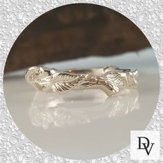 a close up of a silver ring with an animal on it's back end