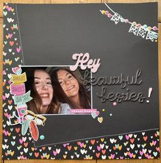 a scrapbook page with two girls smiling for the camera and hearts all around them