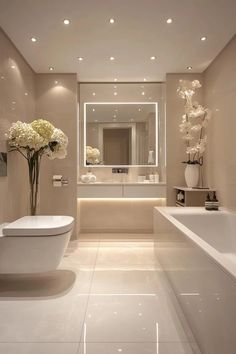 a bathroom with a tub, toilet and sink in it's centerpieces