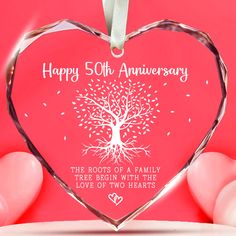 a heart shaped glass ornament with a tree on it and the words happy 50th anniversary