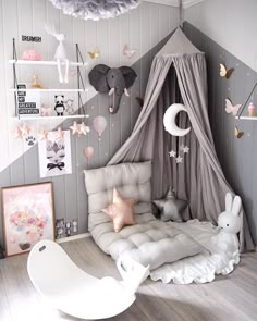 a child's bedroom decorated in pink, grey and white with lots of decorations