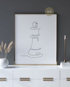 a black and white drawing of a chess piece on a wall next to a dresser