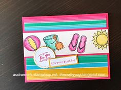 a close up of a card on a table with a sun and beach items in the background