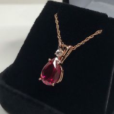 "Beautiful Ruby & White Sapphire Pendant Necklace set in 14k Rose Gold * Pear Cut Ruby measures 10x7mm * Single Brilliant Cut White Sapphire Accent measures 2.5mm * 2.7cts total Gemstone weight * 16\" or 18\" Chain Included * 14k Rose Gold Also Available in Sterling Silver or 14kt Yellow or White Gold - message me for details Hallmarked & Gift Ready! Matching Earrings & Ring Available This Ruby is laboratory grown. It is identical to natural in every way, including Chemistry, Composi Pear-shaped Rose Gold Jewelry With Brilliant Cut, Pear-shaped Brilliant Cut Rose Gold Jewelry, Rose Gold Teardrop Ruby Jewelry, Fine Jewelry Pear-shaped Rose Gold Necklace, Fine Jewelry Rose Gold Pear-shaped Necklace, Rose Gold Ruby Jewelry With Brilliant Cut, Rose Gold Pear-shaped Fine Jewelry Necklace, Rose Gold Pear-shaped Jewelry With Prong Setting, Rose Gold Jewelry With Prong Setting Drop Shape