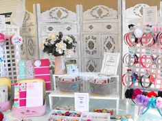 a table topped with lots of different types of items on display in front of a wall