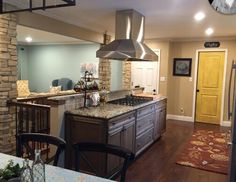 a kitchen with a stove top oven sitting next to a dining room table