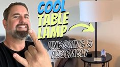 a man is pointing to the side of his lamp that says cool table lamp unboxing and assembly