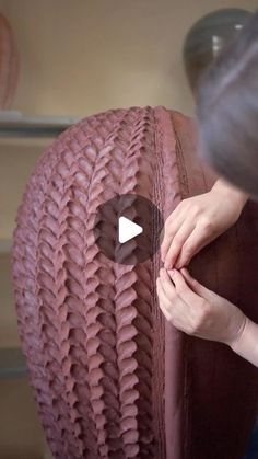 a woman is working on an upholstered chair