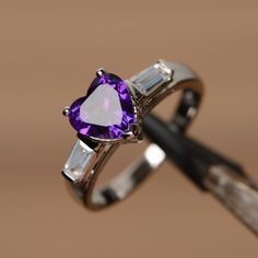 It is real natural amethyst ring, the heart amethyst gemstone is about 8mm*8mm. The basic metal is sterling silver and plated with rhodium. To change the metal to a solid gold (white/rose) or platinum is also available, please ask for a quotation if you want. You can also go to my shop Home for more elegant rings: https://www.etsy.com/shop/godjewelry?ref=hdr_shop_menu Amethyst is the birthstone of January. More amethyst rings: https://www.etsy.com/shop/godjewelry?ref=hdr_shop_menu&section_id Engagement Ring Baguette, Exclusive Engagement Rings, February Birthstone Ring, Elegant Rings, Purple Ring, Pink Morganite Engagement Ring, Baguette Engagement Ring, Ring Baguette, Silver Engagement Ring