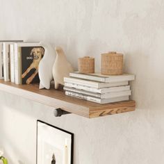 a shelf with books and candles on it