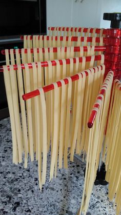 several red and yellow toothpicks are lined up on a counter top next to each other