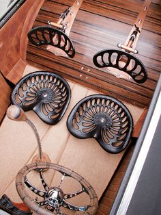 the inside of a boat with wooden flooring and metal wheels on it's center console