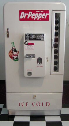 an ice cold machine sitting on top of a checkered floor