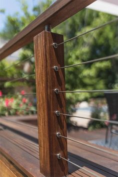 a wooden deck with metal railing and wood slats