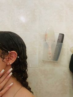 a woman with her hands on her face in front of a hair dryer