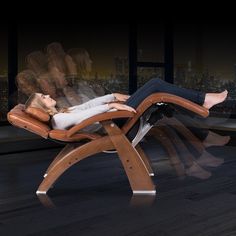 a woman laying on top of a wooden chair in front of a cityscape