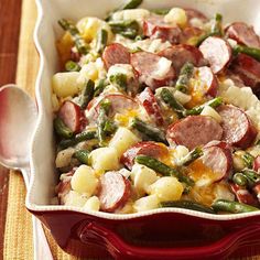 a casserole dish with potatoes, green beans and sausage