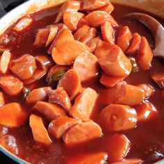 a pot filled with meat and sauce on top of a stove