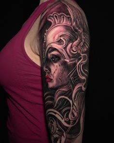 a woman's arm with a tattoo on it and an image of a mask