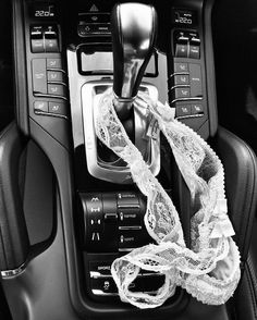 the interior of a car is decorated with white laces and ribbons as well as an automatic gear lever