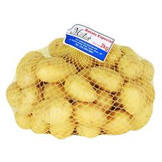 a mesh bag filled with potatoes sitting on top of a white table