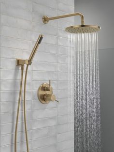 a shower head with thermostaer and hand held shower faucet in gold