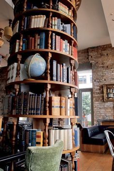 a room filled with lots of books and furniture