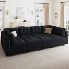 a large black couch sitting in a living room