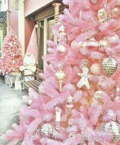 a pink christmas tree decorated with ornaments and other decorations is shown in this instagramtion